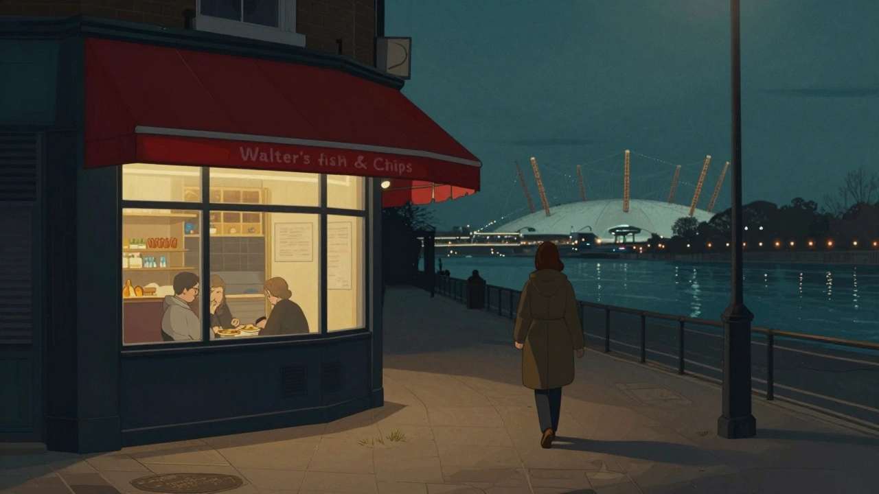 A warm fish and chips shop glows beside the DLR station, with a woman walking toward the quiet River Lea path at night.
