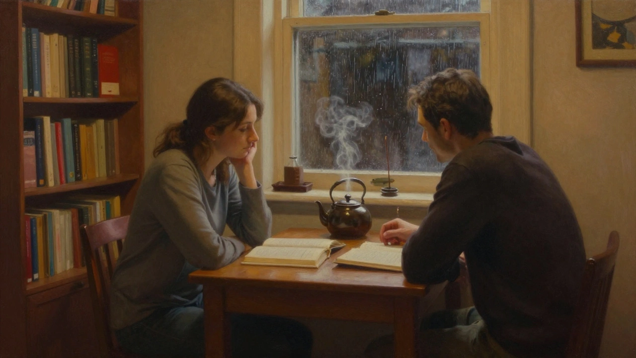 Two people sit quietly at a wooden table in a softly lit room, tea and an open book between them, rain on the window.