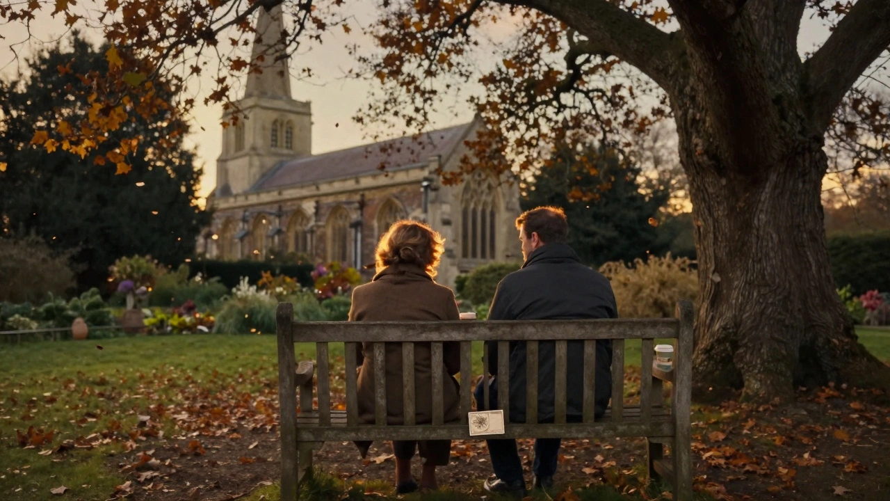 Two people sitting on a bench in St. Mary’s Church Garden at dusk, autumn leaves falling around them.