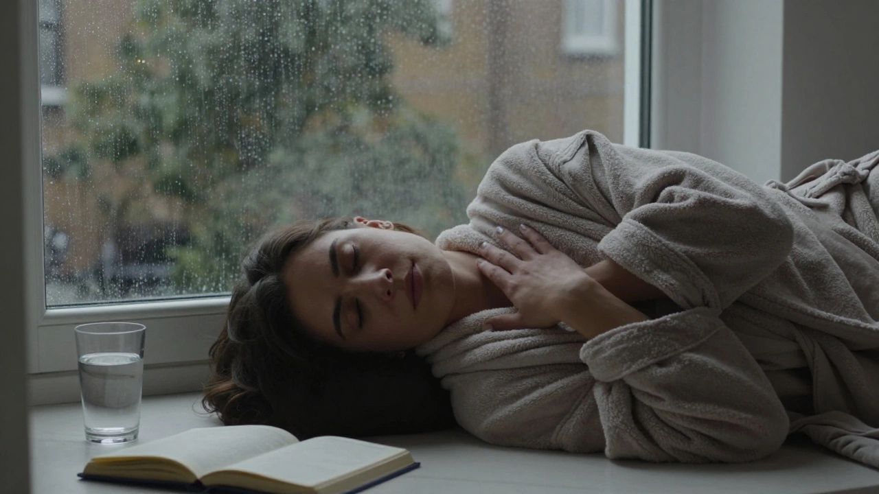 A person at peace after a nuru session, curled on a robe by a rainy window, radiating deep calm and quiet renewal.