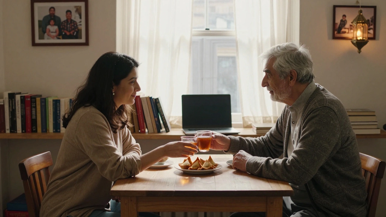 A woman serves tea and samosas to an older client in a quiet rented studio above a chai shop, sunlight filtering through curtains.